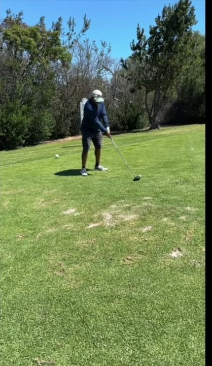The golfer takes his starting position.