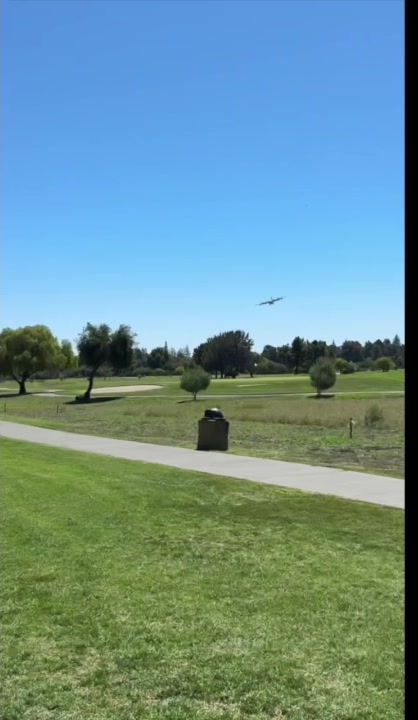 The airplane approaches the golf course.