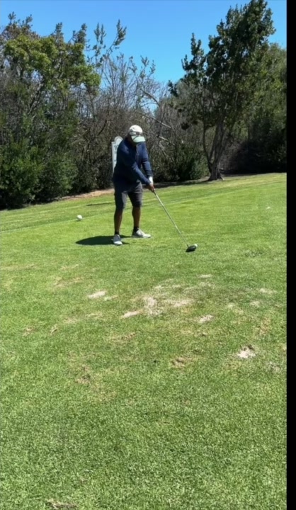 The golfer takes his starting position.